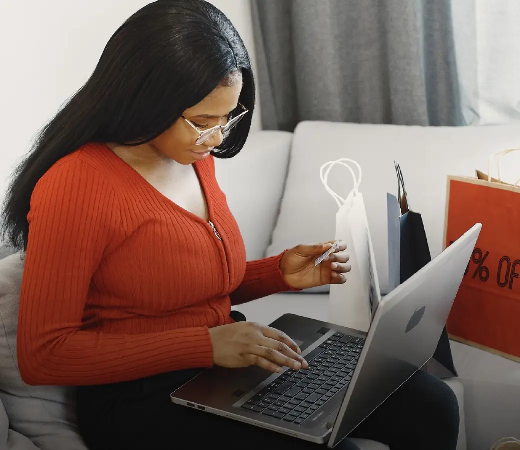 A woman paying for an order on a laptop at home