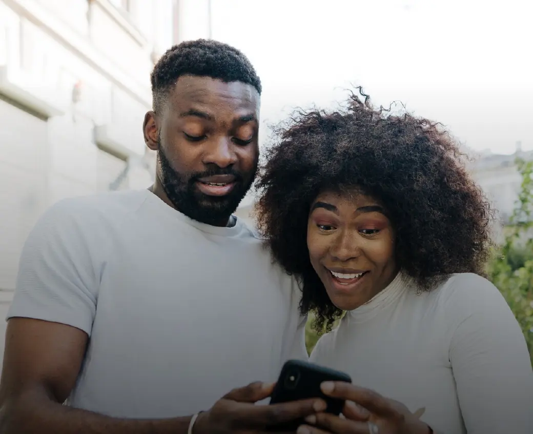 Two friends looking at a phone together