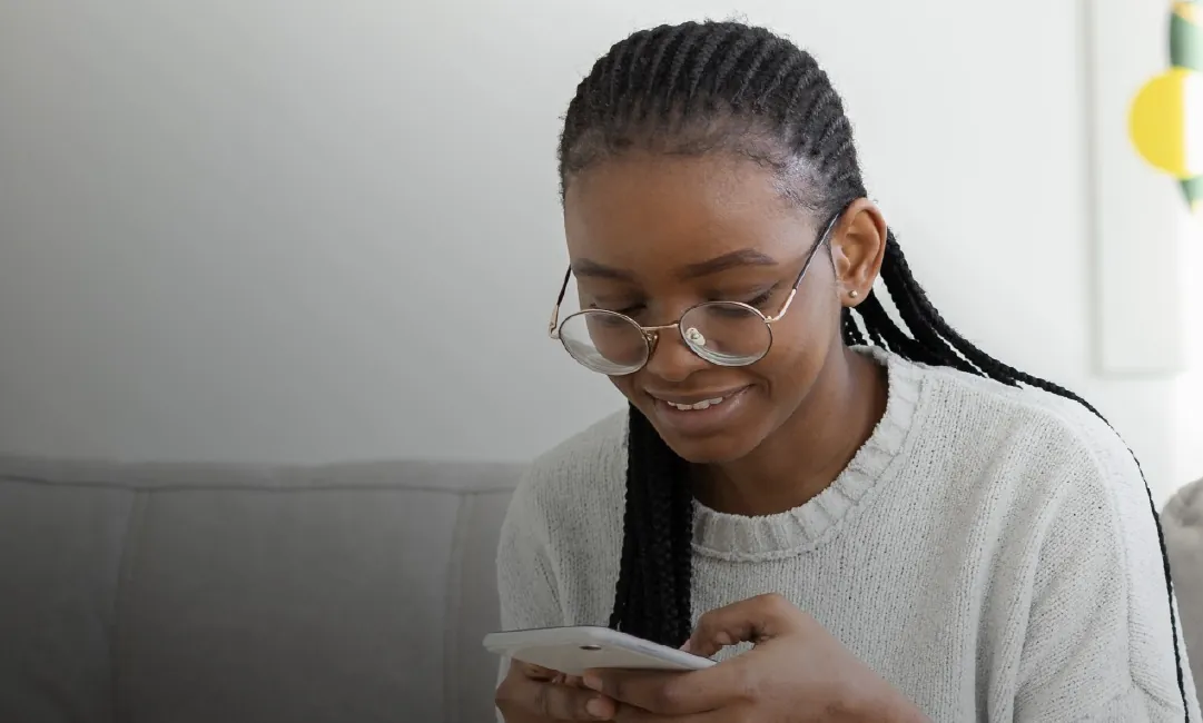 A young woman choosing something to buy on her phone
