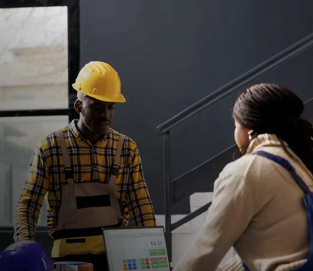 A warehouse worker checking stock with a colleague